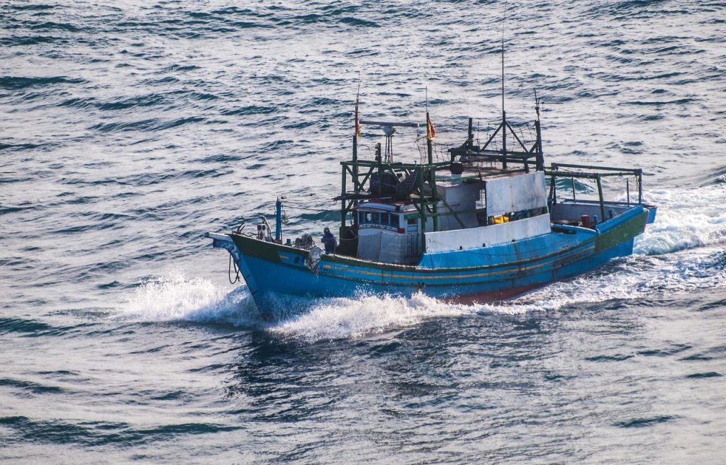 Barco de pesca navegando em meio às ondas do oceano.